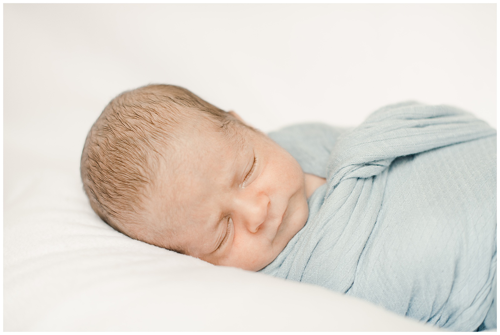 New Orleans Baby Photographer Chelsea Rousey Photography newborn baby boy in blue swaddle
