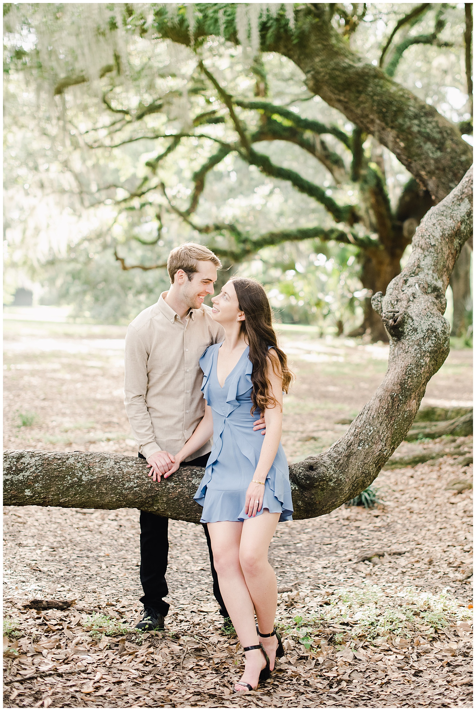 New Orleans Engagement Photos Chelsea Rousey Photography couple in love in city park sitting on tree root