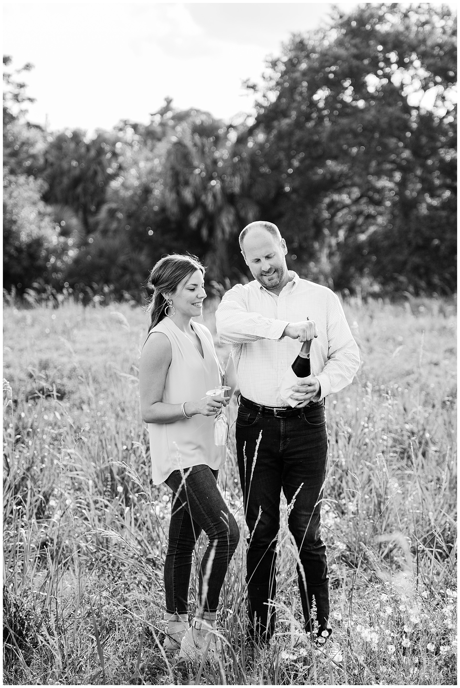New Orleans Engagement Photo Chelsea Rousey Photography black and white couple popping champagne