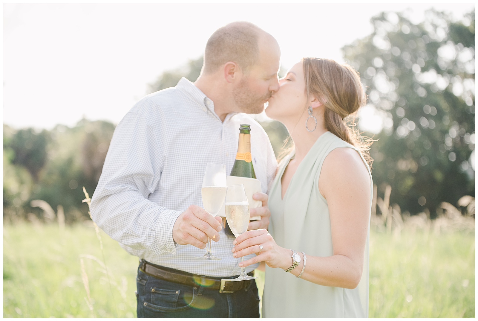 New Orleans Engagement Photos Chelsea Rousey Photography couple kissing holding champagne
